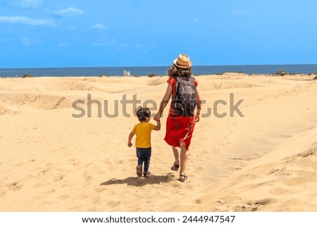 Mother and child on vacation in the dunes of Maspalomas, Gran Canaria, Canary Islands