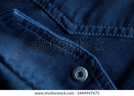 Abstract denim background with button fastening and decorative stitches. Stitching with thread. Photo