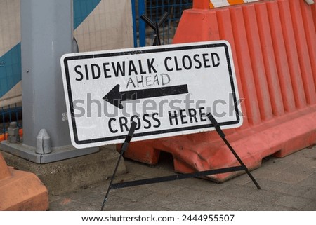 The sign Sidewalk Closed Cross Here Sign