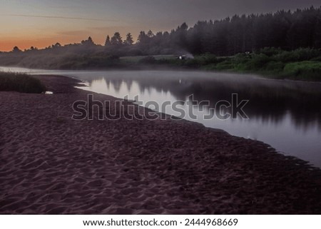 An early morning mist veils the serene Medveditsa river, amidst a tranquil Tver landscape