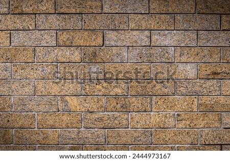 Colorful and patinated brick wall in shades of gray and yellow