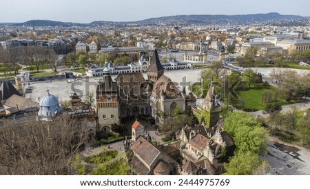 Vajdahunyad Castle, located in Budapest, Hungary, is a stunning architectural marvel that blends various styles from different historical periods captured from a drone Royalty-Free Stock Photo #2444975769
