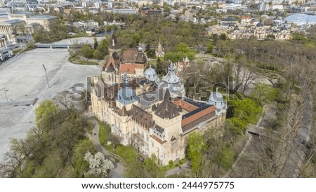 Vajdahunyad Castle, located in Budapest, Hungary, is a stunning architectural marvel that blends various styles from different historical periods captured from a drone Royalty-Free Stock Photo #2444975775