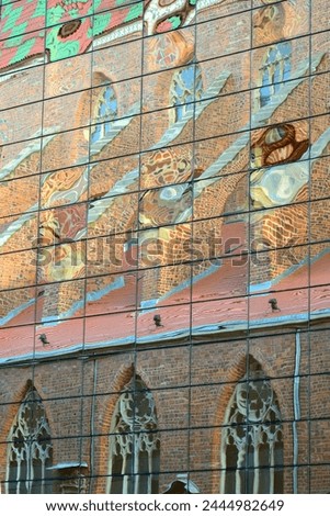 Wroclaw, Poland. St. Mary Magdalene's Church in Wroclaw city reflection in the glass facade of the modern building  Royalty-Free Stock Photo #2444982649