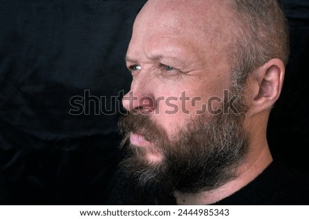 Men's beard. The guy's face is large. Brutal macho. Mustache and beard. Barber. Lumberjack. Portrait of a handsome man with a beard                               Royalty-Free Stock Photo #2444985343