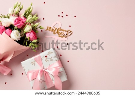 Bouquet of roses, Happy mother's day sign, gift box on pink background. Mothers Day greeting card design. Flat lay, top view.