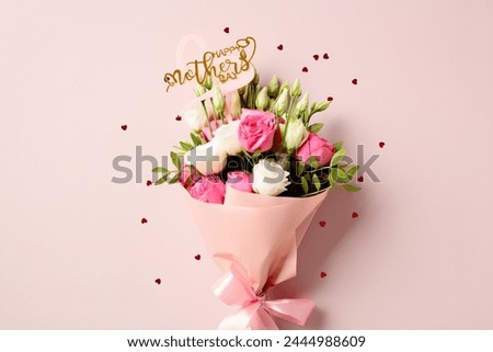 Bouquet of flowers with sign Happy Mother's Day on pastel pink background decorated heart shaped confetti.