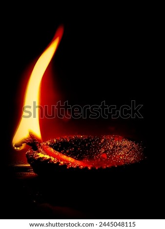 oil lamp picture yellow flame black background