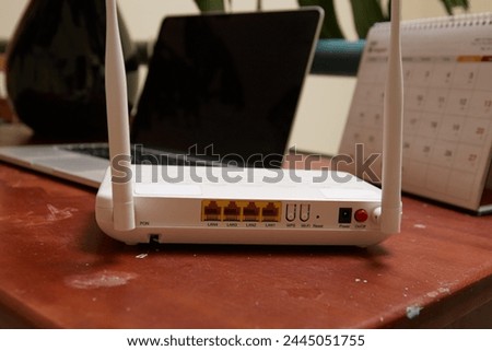 Photo of Wifi Router and laptop on the wooden table 