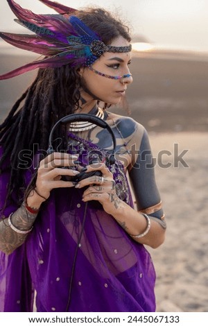 A woman in a vibrant purple dress is accessorizing with a pair of electric blue headphones. Her outfit is a trendy mix of fashion design and performing arts aesthetics