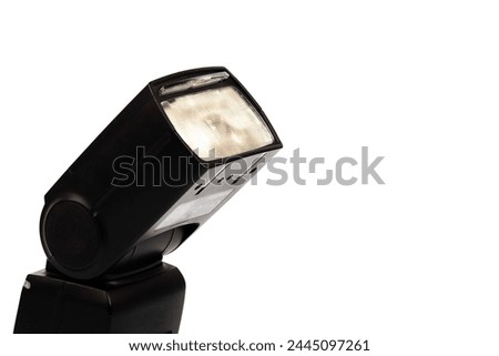 Flash for a camera. On a white background. space for a text label. on modern black flash. on a white background. To illuminate the subject, people.
