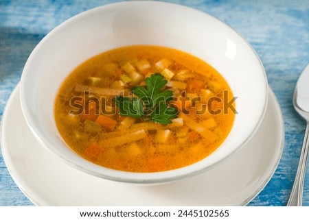 Top view of healthy vegetable soup on white porcelain plate