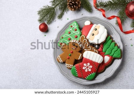 Tasty homemade Christmas cookies and decor on light grey table, flat lay. Space for text