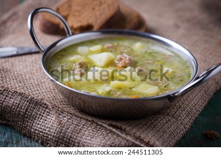 Fresh appetizing  soup with meat and vegetables  in  bowl on table. Selective focus. Royalty-Free Stock Photo #244511305