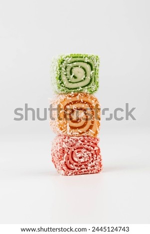 Traditional Turkish delight isolated on white background. 
Sweet delicious lukum color Royalty-Free Stock Photo #2445124743