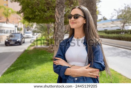 Young girl wearing sunglasses posing outdoors