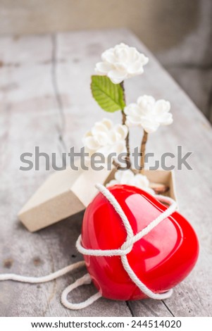 Red hearts and flowers on a wooden