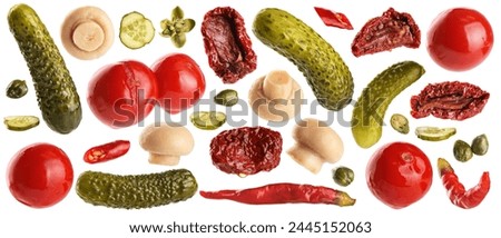 Pickled champignons, cucumbers, tomatoes, capers, chili pepper and sun dried tomatoes isolated on white background. Collection with clipping path. Royalty-Free Stock Photo #2445152063