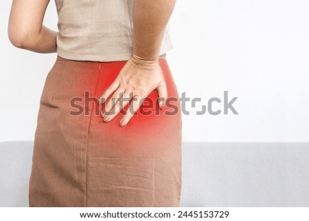 woman suffering from Piriformis Syndrome , feeling pain and numbness in butt, hip or upper leg Royalty-Free Stock Photo #2445153729