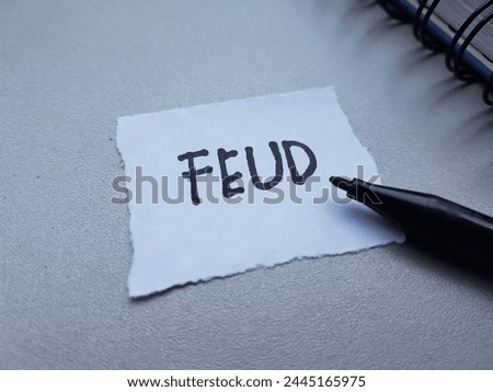Feud writting on table background. Royalty-Free Stock Photo #2445165975