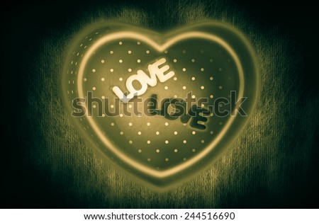 Heart-shaped gift box and two text "LOVE" middle box with magic heart-shape glowing lines on dark background low key lighting vintage picture style for a Valentine's day, love concept