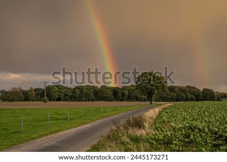 Rainclouds and a rainbow near Retelitz, Mecklenburg-Western Pomerania, Germany Royalty-Free Stock Photo #2445173271
