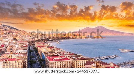 amazing Naples landscape of Vomero hill with beautiful streets and buildings of Napoli city, blue sea gulf and volcano Vesuveus with sunset of sunrise cloudy sky on background Royalty-Free Stock Photo #2445173975