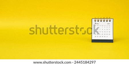 a desk calendar for May 2024 year on a yellow background. banner. space for text