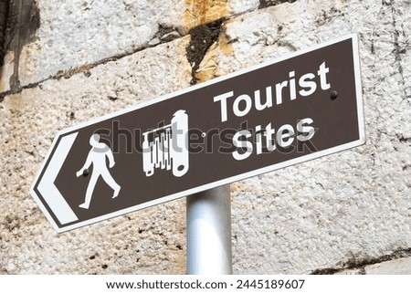 Brown tourism information sign at Gibraltar, pointing the way to tourist sites for great holiday photos.