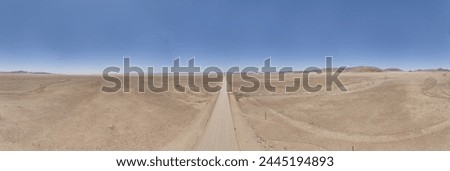 Panoramic drone picture of lonely gravel road through the desert on the edge of the Namib-Naukluft National Park in Namibia during the day