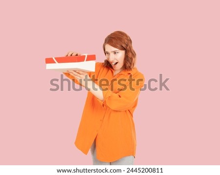 Looking inside opening gift box, portrait of excited happy red bob hair caucasian woman looking inside opening gift box. What a great surprise concept idea image. People lifestyle.