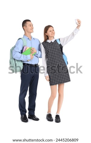 Students with books taking selfie on white background. End of school concept