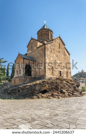 Awesome view of the Virgin Mary Assumption Church of Metekhi on the cliff over the Kura (Mtkvari) River in Tbilisi, Georgia. The Georgian Orthodox Christian church is a popular tourist attraction. Royalty-Free Stock Photo #2445208637