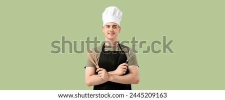 Male confectioner with whisks on green background with space for text Royalty-Free Stock Photo #2445209163