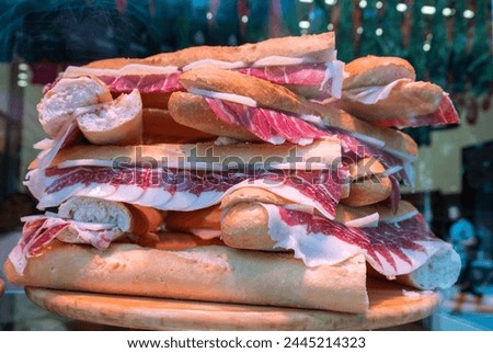Snacks of exquisite and healthy Spanish Iberian ham on a table for sale in food market Royalty-Free Stock Photo #2445214323