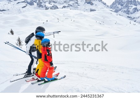 Picture of mother teach skiing her kids in Madonna di Campiglio