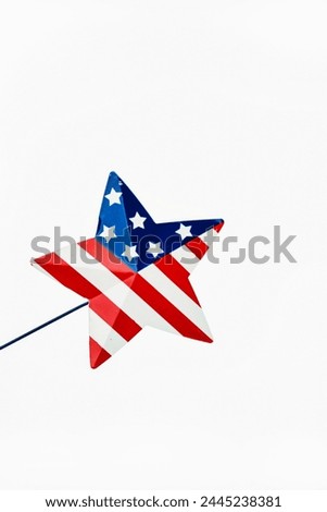 A Miniature Star on a Stick with Stars and Stripes, white background.......