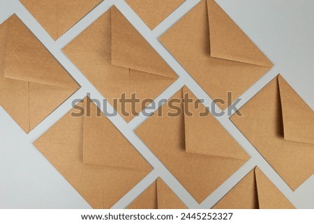 Top view of kraft brown envelopes on grey background. Post flat lay. Copy space.