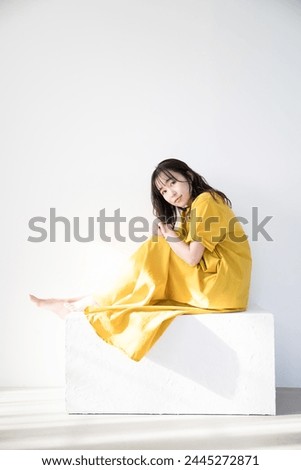 Woman in yellow dress under the sun Beauty and beauty sun image Tanning, UV, etc.	