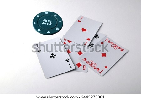 Aces playing cards with a usd 25 casino chip on a white background.