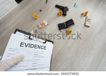 Close up on hands of unknown man forensic police investigator collecting evidence in the plastic bag at the crime scene investigation Royalty-Free Stock Photo #2445275033