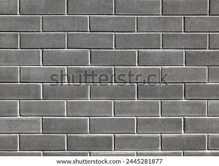 A smooth textured grey brick wall with perfectly laid bricks creating a beautiful background texture. An organic texture for use as a background in graphic design to create a modern,  urban style