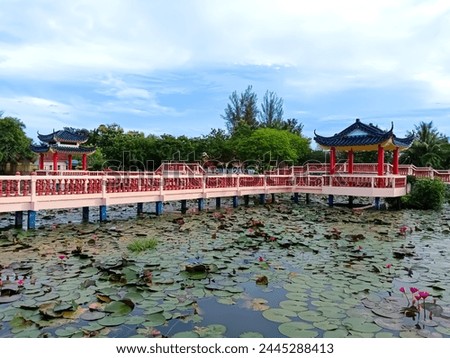 The structure bridge Tasik Melati is very heritage and traditional architectural design. The beautiful flowers at the lake are red or pink lotus flowers.