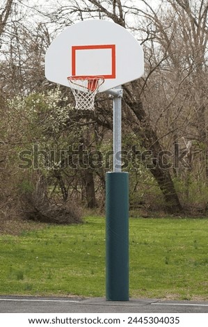 This is an outdoor basketball goal and backboard. Royalty-Free Stock Photo #2445304035