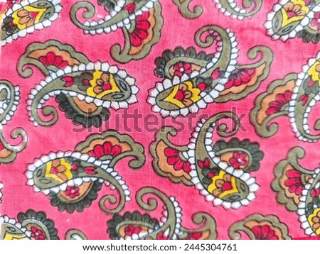 Assorted curly paisley print on a hot pink fabric 