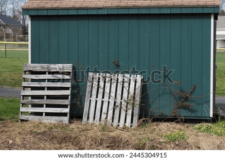 This green shed stores the equipment  for the nearby baseball fields.   Royalty-Free Stock Photo #2445304915
