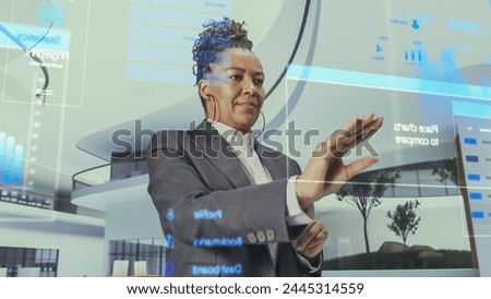 Futuristic Black Business Leader Businesswoman Standing in Virtual Space, Gesturing with an Augmented Reality Hologram Analysing Data, Financial Reports, Stock Market Statistics, Infographics