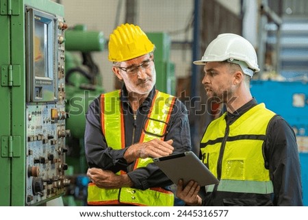 Two professional engineer worker technician checking old machine construction factory with colleague technician. factory assistant worker in helmet check old machinery construction in old factory. Royalty-Free Stock Photo #2445316577