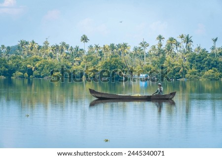 Fisherman in a boat fishing in the backwaters of kerala, India. Royalty-Free Stock Photo #2445340071