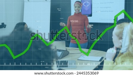 Image of graph and changing numbers over diverse woman sharing ideas with coworkers in meeting. Digital composite, multiple exposure, business, growth, planning and teamwork concept.